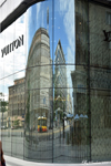 The glass façade of Vuitton reflects the buildings of Jerozolimskie Street