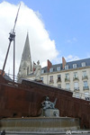 The fountain of the Place Royale with the cathedral in the background