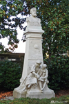 Monument to Jules Verne in the Jardin des Plantes with two children reading "Voyages extraordinaires". Jules Verne was born in Nantes and died in Amiens